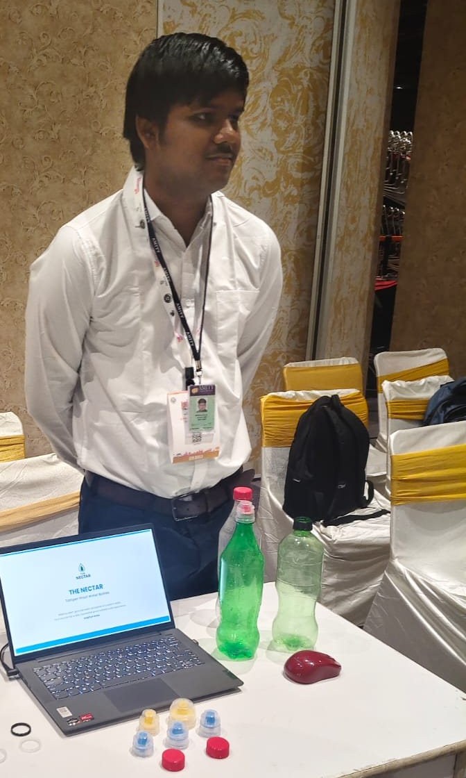 The Nectar stall at the expo, with bottles, caps and the website on a laptop